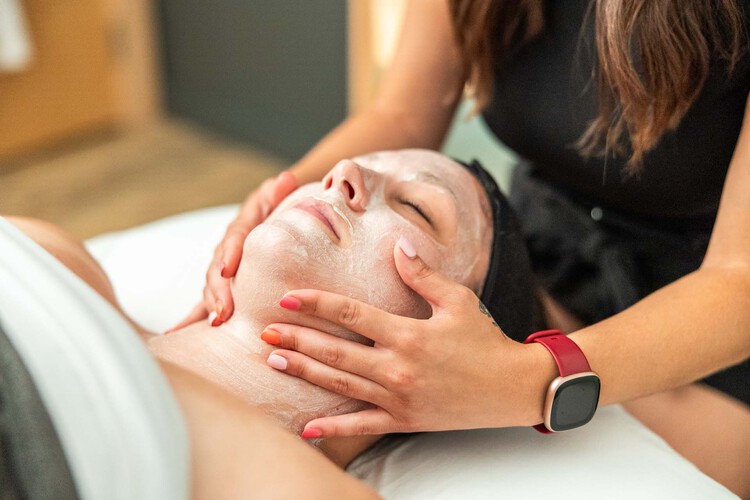 A woman receiving a facial